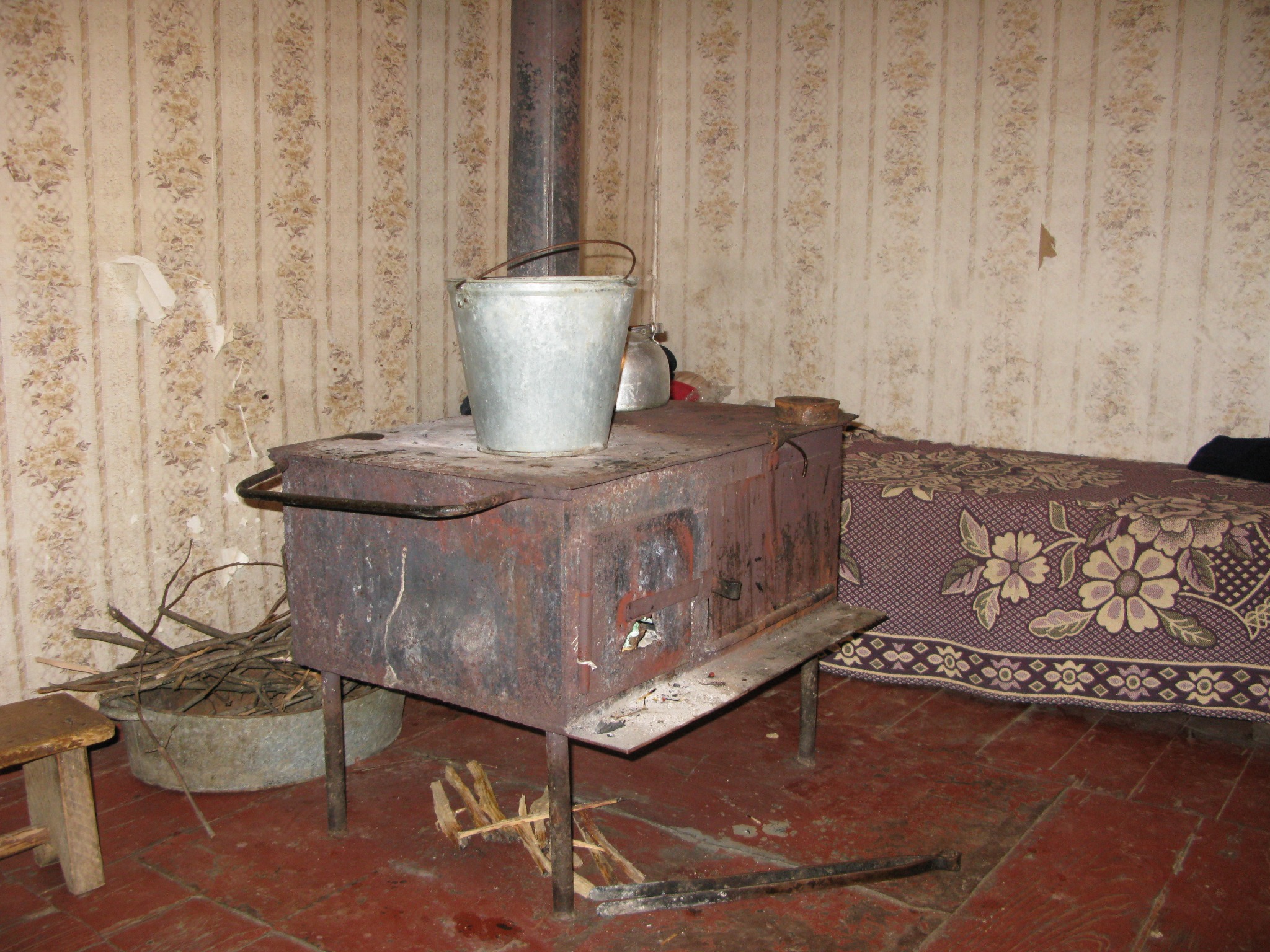 Room with a wood-burning stove in Nigvzara, August 2008